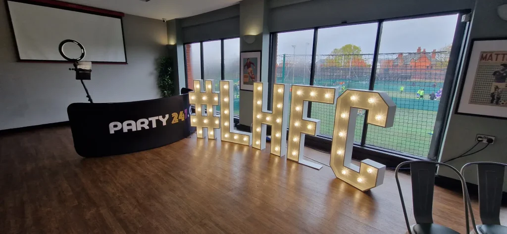 Light-up letters and a Party247 booth at a corporate venue